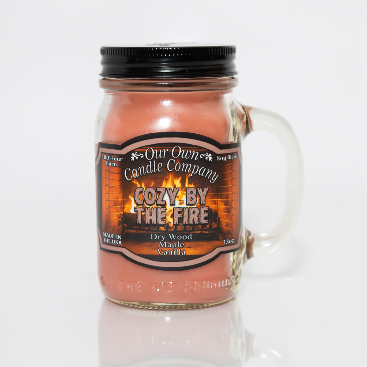 Our Own Candle Company Cozy by the Fire scented candle in a 13 oz glass mason jar with lid