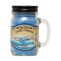 Our Own Candle Company The Beach 13 oz mason jar candle, blue soy wax in a glass handled jar with black lid, citrus, driftwood and amber scent