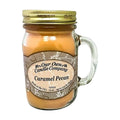 Our Own Candle Company Caramel Pecan 13 oz mason jar candle, caramel-colored soy wax in a clear glass handled jar with gold metal lid and tan scrollwork label, caramel, toasted pecan and sweet musk scent