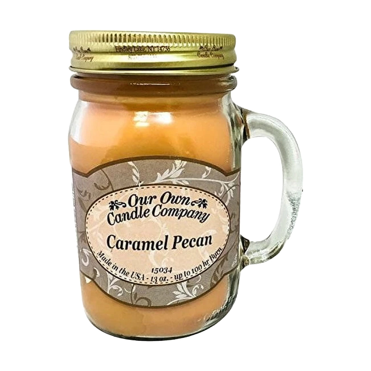 Our Own Candle Company Caramel Pecan 13 oz mason jar candle, caramel-colored soy wax in a clear glass handled jar with gold metal lid and tan scrollwork label, caramel, toasted pecan and sweet musk scent