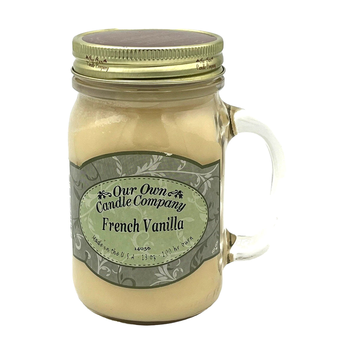 Our Own Candle Company French Vanilla 13 oz mason jar candle, cream-colored soy wax in a clear glass handled jar with gold metal lid and sage green scrollwork label, sweet creamy vanilla scent