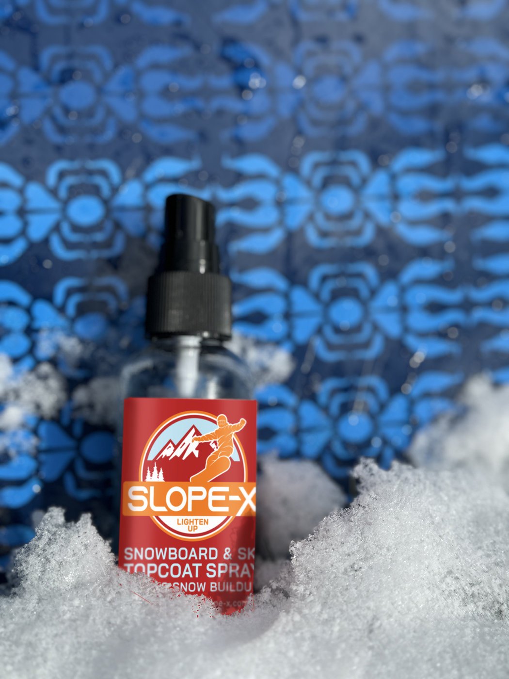 Slope-X snow repellent spray bottle standing in fresh snow