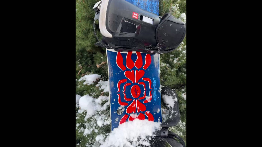 Snow sliding off a snowboard treated with Slope-X topcoat